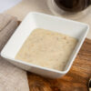 banana porridge meal replacement in a square white bowl