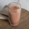 chocolate smoothie meal replacement in a glass with a straw