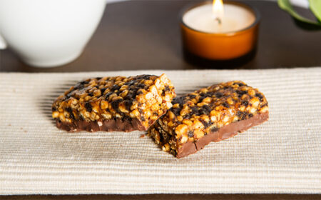 Two halves of a chocolate peanut meal replacement bar